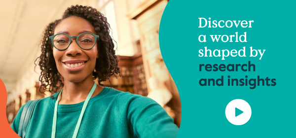 A teacher wearing glasses smiles at the camera. Text: Discover a world shaped by research and insights