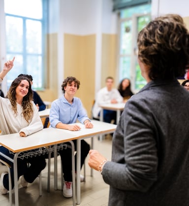 Teacher in a classroom front of teenage students