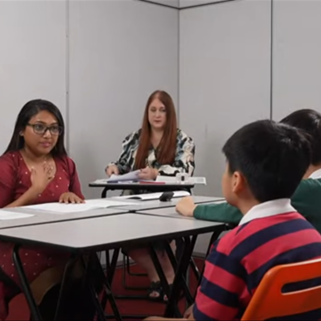 A Speaking test takes place with two examiners and two students