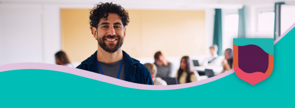 Image of smiling teacher in front of classroom
