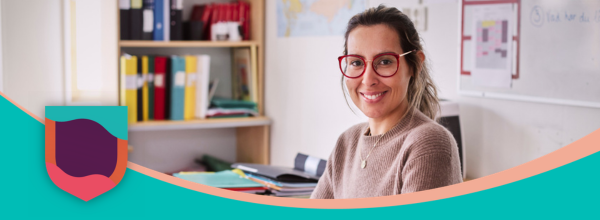 A teacher smiling in a classroom
