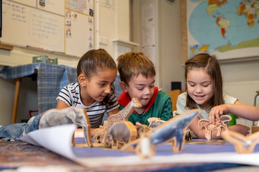 Young children playing with animal toys